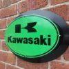 Green Kawasaki logo and sign