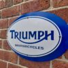 Side view of Triumph mild steel sign