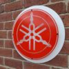 Side view of Yamaha red mild steel sign