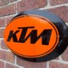 Handmade orange and black KTM sign.
