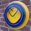 Handmade blue and yellow circular sign featuring the Leeds United Football Club 'smiley' style badge.