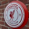 Handmade red and white circular sign featuring the Liverpool Football Club badge.