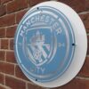 Handmade sky blue and white circular sign featuring the Manchester City Football Club badge.